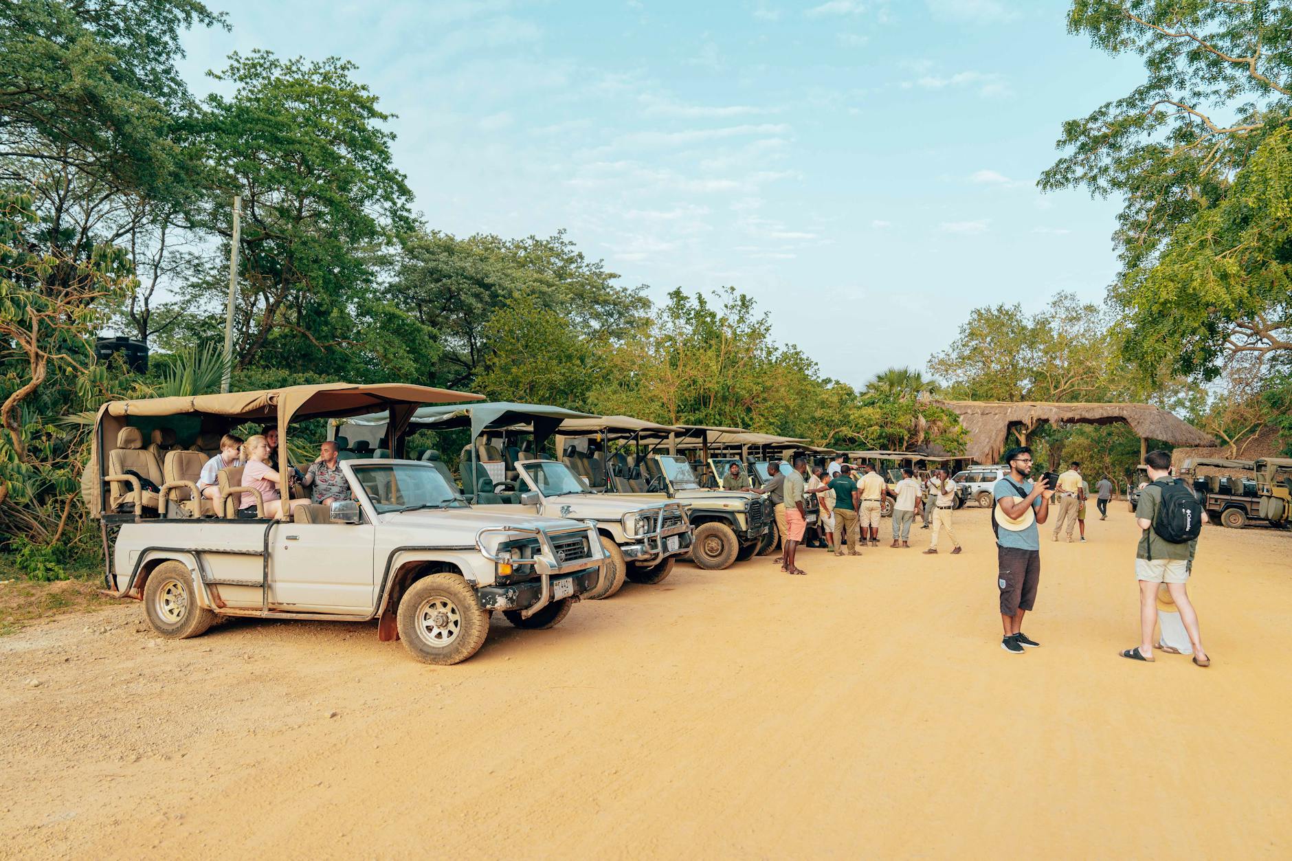 Turyści wsiadają do odkrytych jeepów safari przed wycieczką
